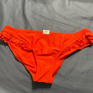 Salmon orange ruffled bikini bottoms.